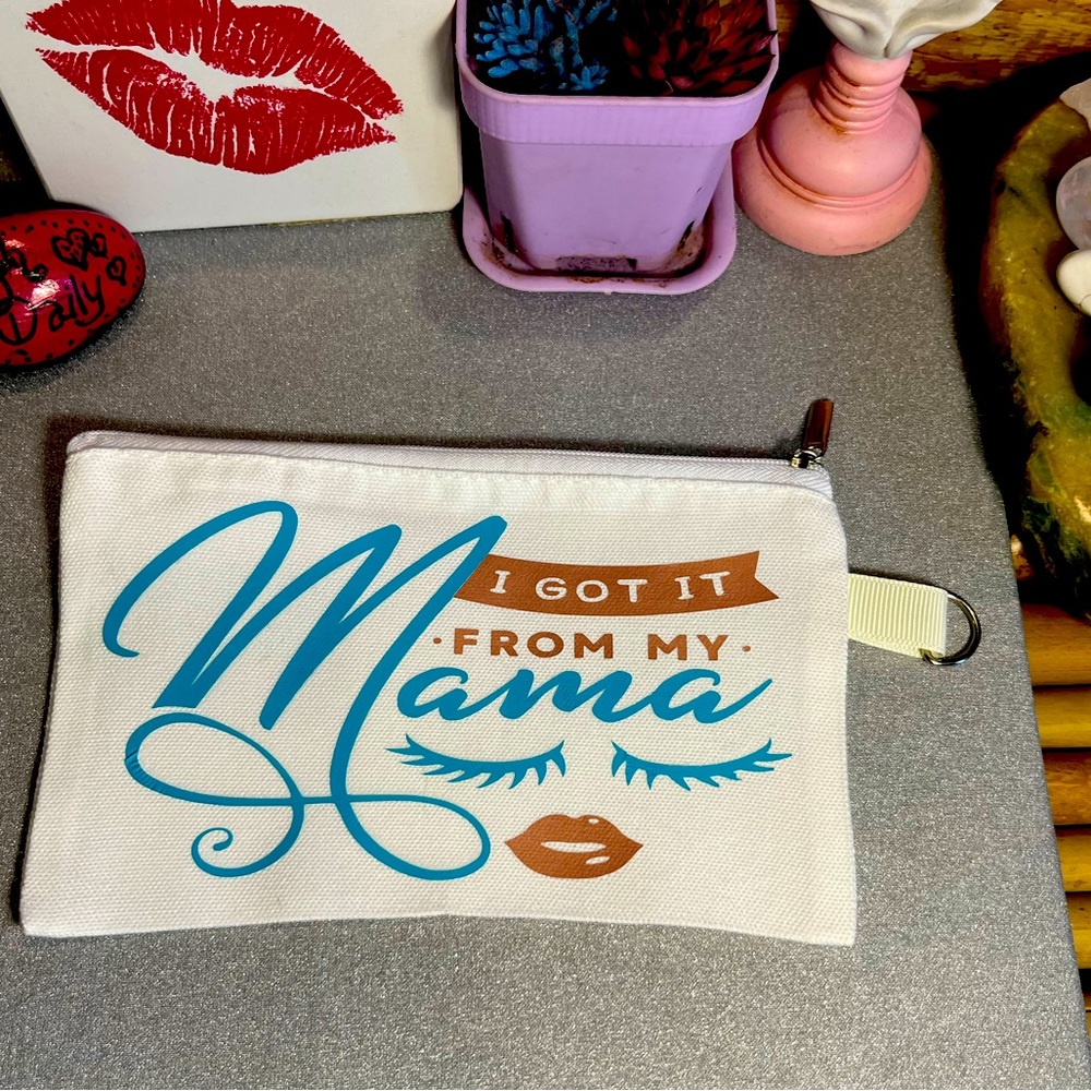 Small white canvas makeup bag with zipper and keychain ring. 💋